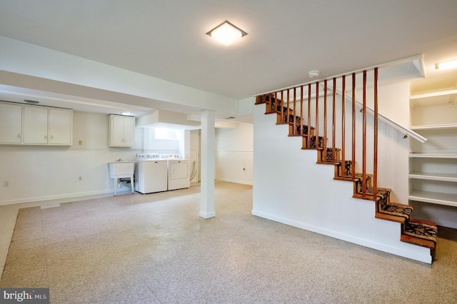 finished basement with stairway, baseboards, and washer and dryer