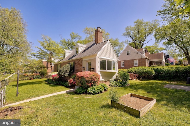 view of side of home featuring a chimney, a yard, and a garden