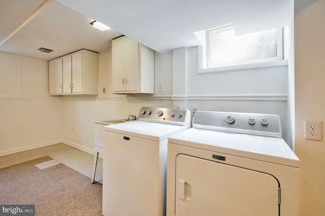 laundry area featuring cabinet space, baseboards, and washer and clothes dryer