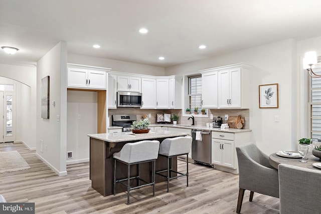 612 Greenbriar Path, Cochranville, PA 19330 - kitchen with stainless steel appliances, light wood-style floors, white cabinetry, backsplash, and recessed lighting