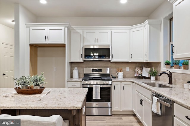 612 Greenbriar Path, Cochranville, PA 19330 - kitchen with stainless steel appliances, white cabinets, recessed lighting, light wood-style flooring, and backsplash