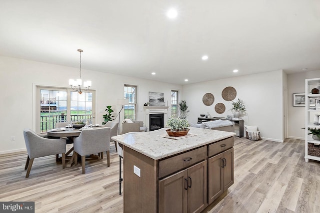 612 Greenbriar Path, Cochranville, PA 19330 - kitchen featuring light wood-type flooring, recessed lighting, a glass covered fireplace, a chandelier, and a kitchen island