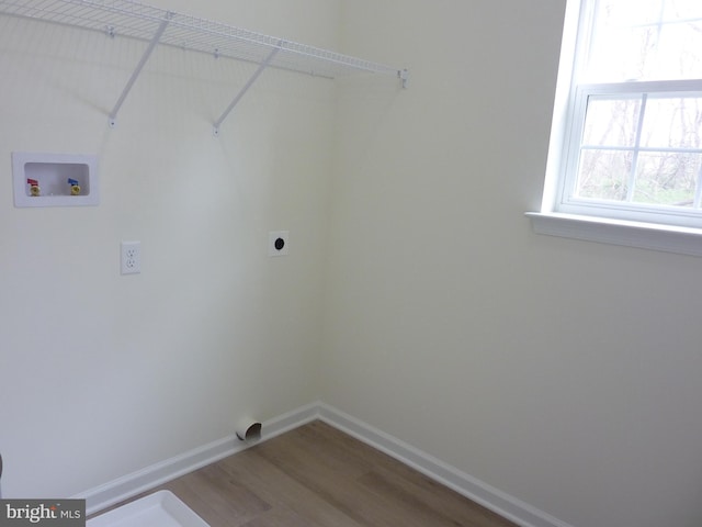 washroom featuring baseboards, laundry area, wood finished floors, electric dryer hookup, and hookup for a washing machine