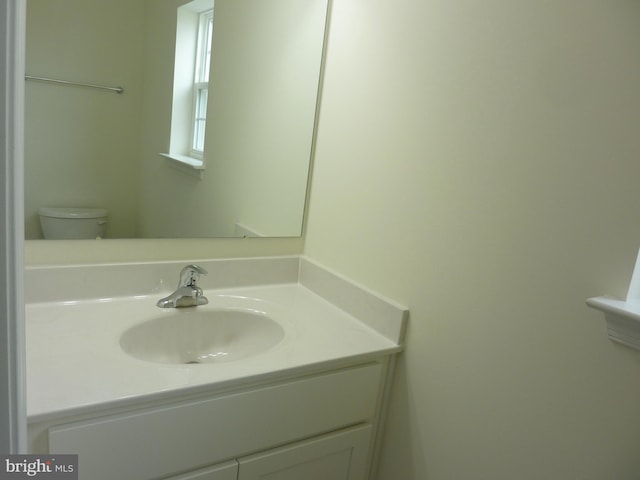 bathroom featuring toilet and vanity