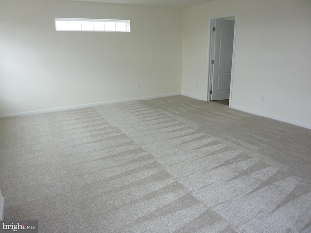 carpeted empty room with baseboards