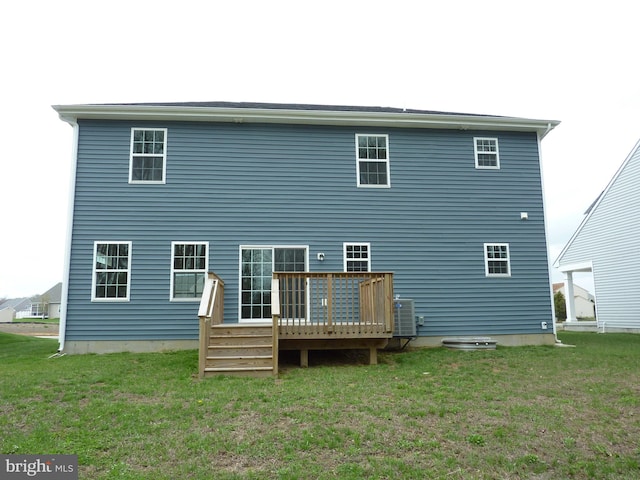 rear view of property featuring central AC, a wooden deck, and a lawn