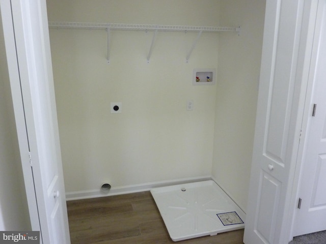 laundry area featuring laundry area, electric dryer hookup, wood finished floors, washer hookup, and baseboards