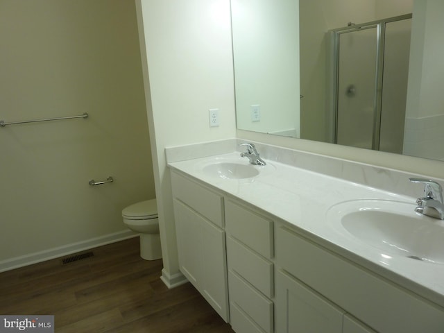 full bath featuring a sink, visible vents, a stall shower, and wood finished floors