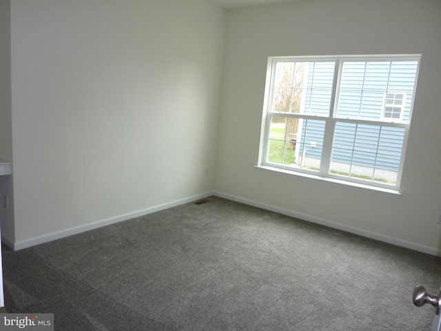 empty room with carpet flooring and baseboards
