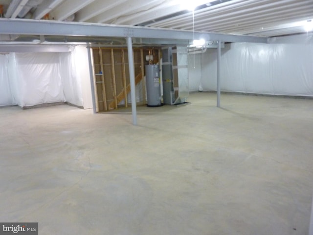 unfinished basement with electric water heater and heating unit