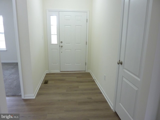 interior space with wood finished floors, baseboards, and visible vents