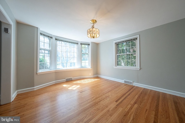 7411 Elizabeth Rd, Elkins Park, PA 19027 - spare room featuring a chandelier, wood finished floors, and baseboards