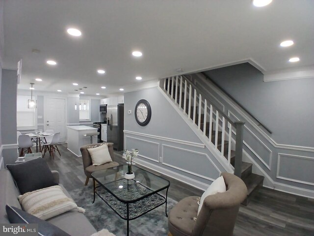 300 Denison St, Baltimore, MD 21229 - living area featuring recessed lighting, stairs, dark wood-style floors, and a decorative wall