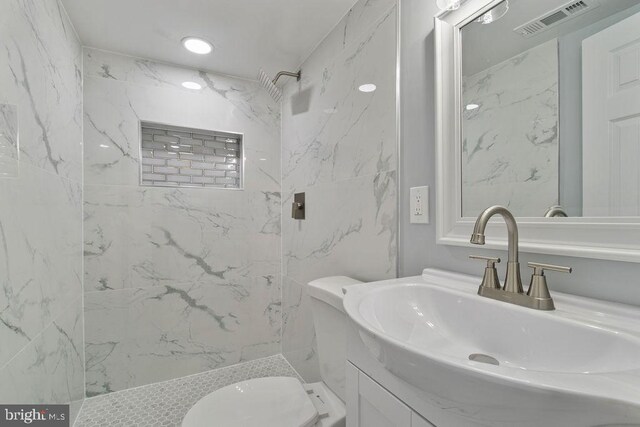 300 Denison St, Baltimore, MD 21229 - bathroom with toilet, vanity, visible vents, and a marble finish shower