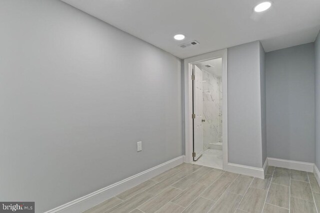 300 Denison St, Baltimore, MD 21229 - spare room featuring wood finish floors, baseboards, visible vents, and recessed lighting