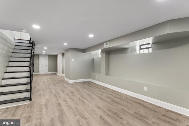 basement with stairway, wood finished floors, baseboards, and recessed lighting