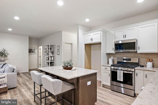 610 Greenbriar Path, Cochranville, PA 19330 - kitchen featuring stainless steel appliances, open floor plan, white cabinets, recessed lighting, and backsplash