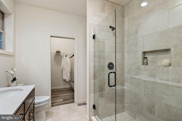 610 Greenbriar Path, Cochranville, PA 19330 - bathroom featuring a shower stall, a spacious closet, vanity, and tile patterned flooring
