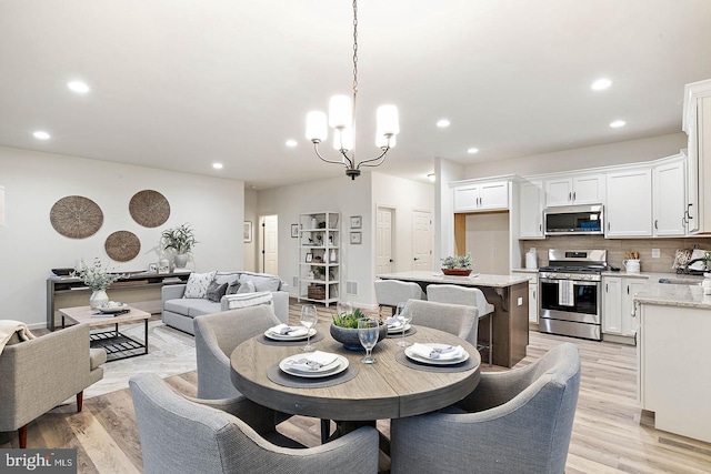 610 Greenbriar Path, Cochranville, PA 19330 - dining area featuring recessed lighting, light wood-type flooring, and a chandelier