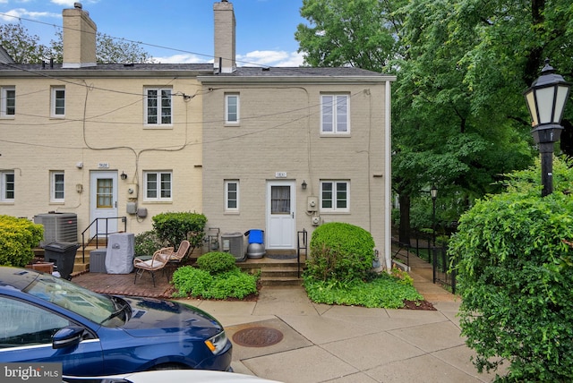 9830 Hollow Glen Pl Unit 2562, Silver Spring, MD 20910 - back of house featuring central AC unit, fence, and a chimney