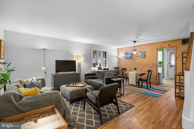 9830 Hollow Glen Pl Unit 2562, Silver Spring, MD 20910 - living area featuring wood walls and light wood-type flooring
