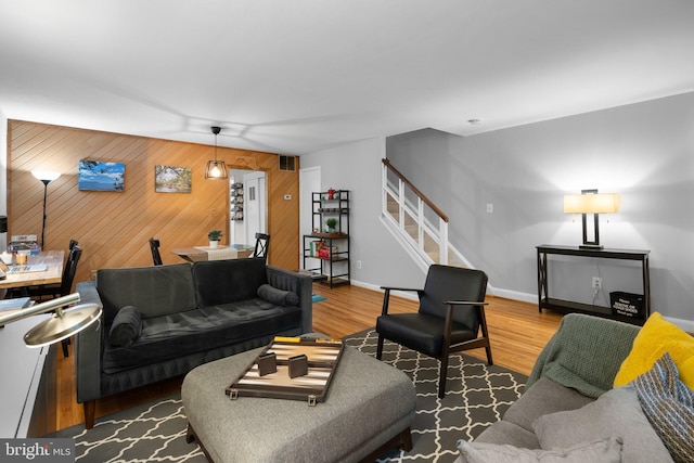 9830 Hollow Glen Pl Unit 2562, Silver Spring, MD 20910 - living room featuring stairway, wood finished floors, wooden walls, and baseboards
