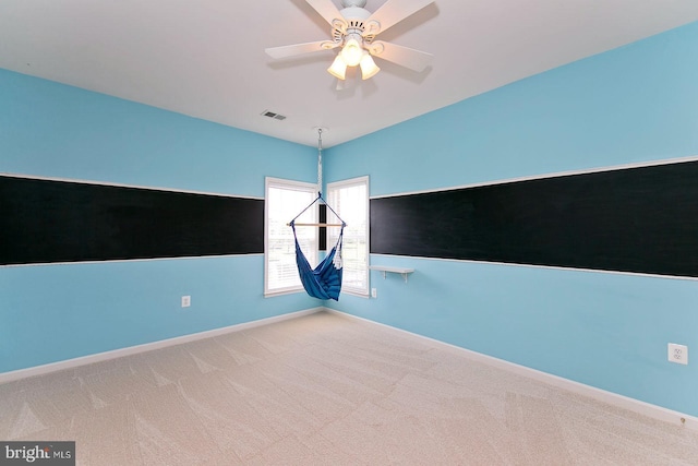 unfurnished room featuring ceiling fan, baseboards, carpet, and visible vents