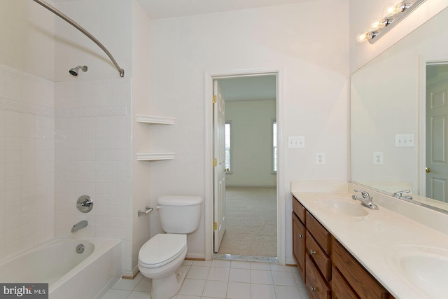 full bath with a sink, toilet, double vanity, tile patterned floors, and bathing tub / shower combination