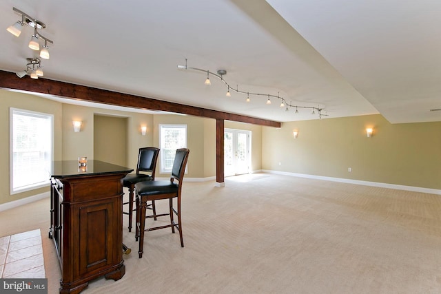 kitchen with light carpet, baseboards, and track lighting