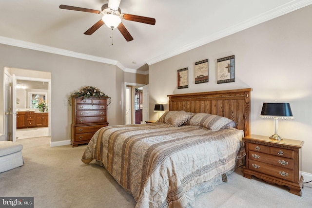 bedroom featuring baseboards, ornamental molding, ensuite bathroom, ceiling fan, and light colored carpet