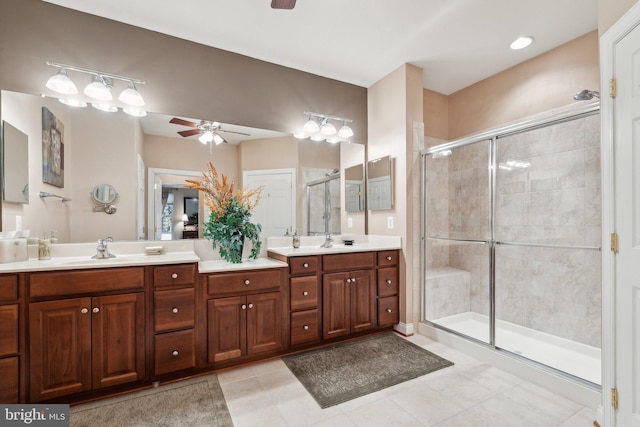 bathroom featuring tile patterned floors, ceiling fan, a shower stall, and double vanity