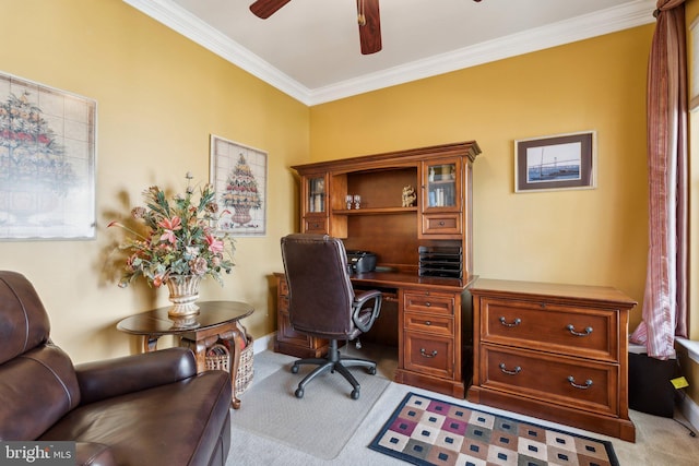 office area featuring light carpet, baseboards, crown molding, and ceiling fan
