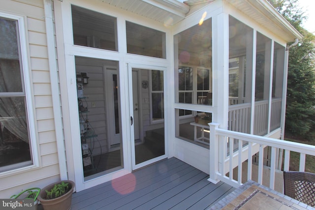 wooden deck with a sunroom