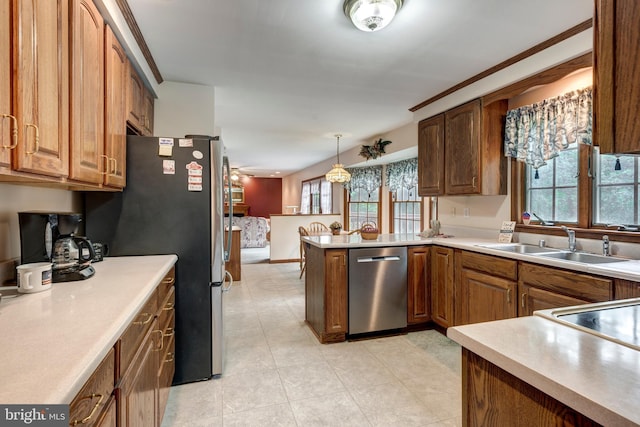 2744 Church Ln, Taneytown, MD 21787 - kitchen featuring stainless steel appliances, a peninsula, hanging light fixtures, brown cabinetry, and light countertops