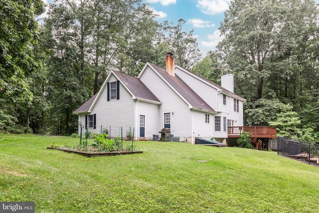 2744 Church Ln, Taneytown, MD 21787 - rear view of house featuring a chimney, a garden, a wooden deck, roof with shingles, and view of wooded area