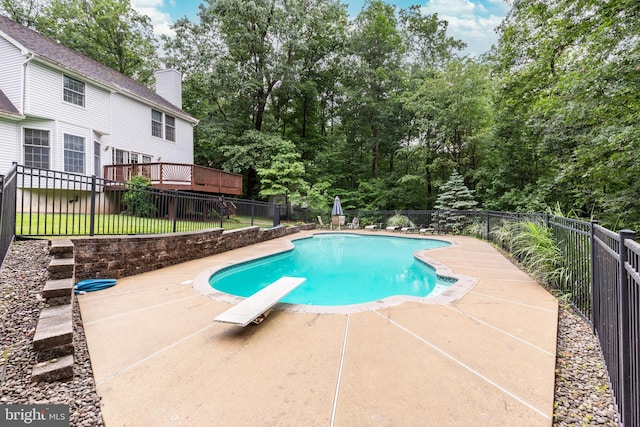 2744 Church Ln, Taneytown, MD 21787 - view of pool featuring a diving board, a patio, a wooden deck, and view of wooded area