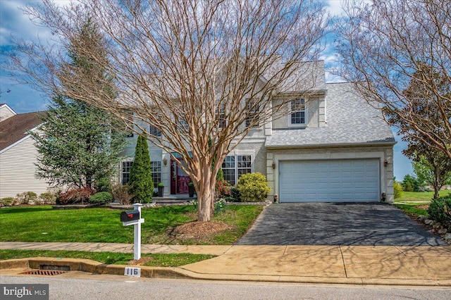 view of front facade featuring a garage, roof with shingles, driveway, and a front lawn