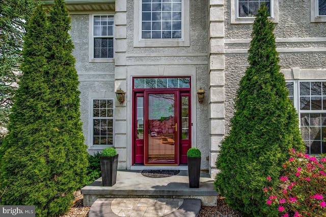 property entrance with stucco siding