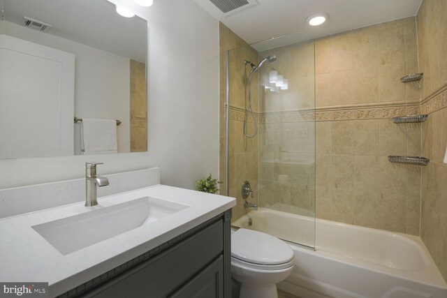 bathroom featuring toilet, shower / washtub combination, vanity, and recessed lighting