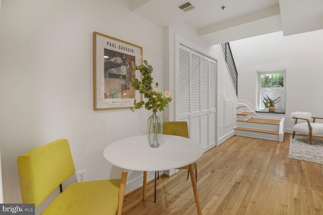 sitting room featuring wood finished floors, stairs, and baseboards
