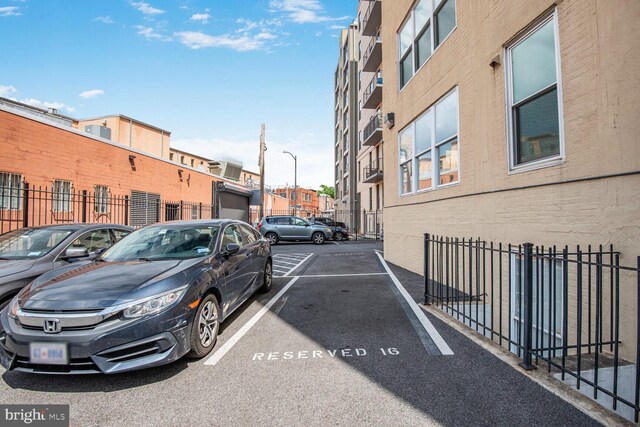 uncovered parking lot featuring fence