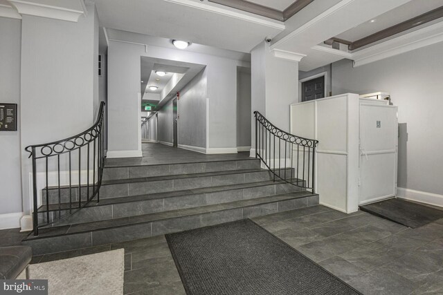 stairway featuring baseboards