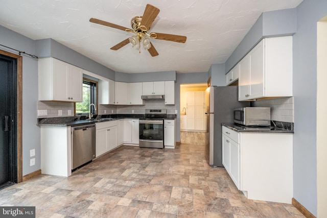 208 Drane Dr, Accident, MD 21520 - kitchen with white cabinetry, a sink, dark countertops, and appliances with stainless steel finishes