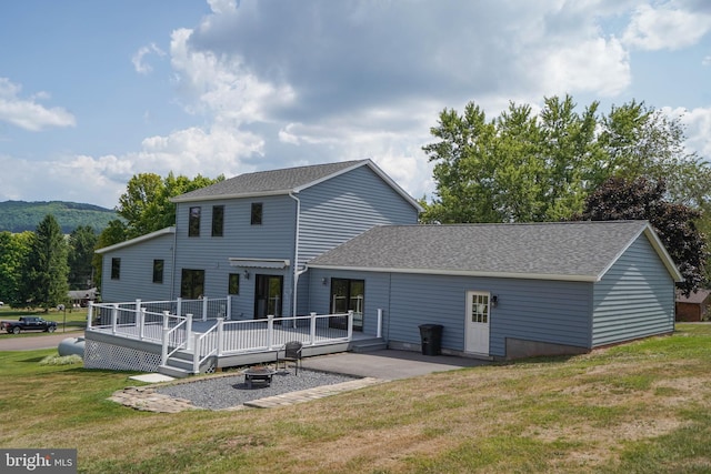 208 Drane Dr, Accident, MD 21520 - back of house with an outdoor fire pit, a wooden deck, roof with shingles, and a yard