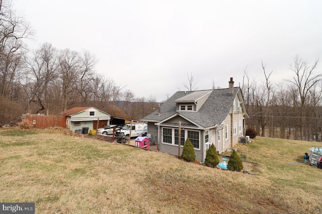 138 Seyfert Dr, Birdsboro, PA 19508 - view of home's exterior with central AC, a yard, fence, a chimney, and a shingled roof