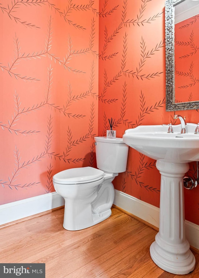 607 Newtown Rd, Berwyn, PA 19312 - half bath with baseboards, wood finished floors, toilet, and wallpapered walls