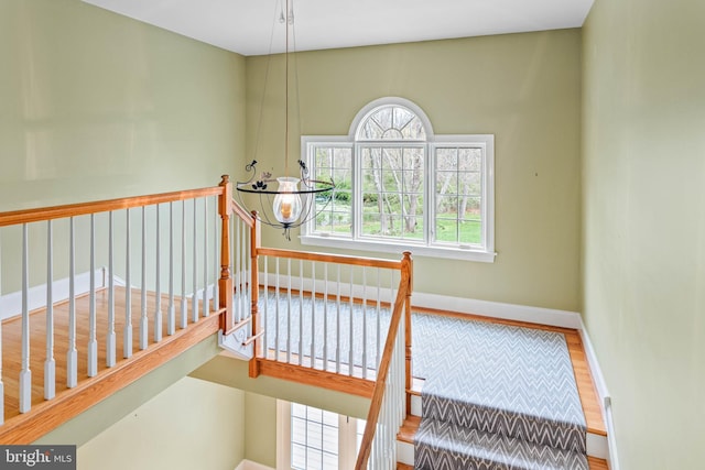 607 Newtown Rd, Berwyn, PA 19312 - staircase featuring baseboards and a notable chandelier