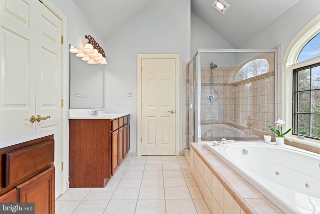 607 Newtown Rd, Berwyn, PA 19312 - bathroom with vanity, tile patterned floors, a jetted tub, a shower stall, and vaulted ceiling