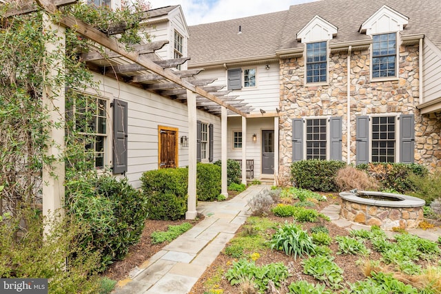 607 Newtown Rd, Berwyn, PA 19312 - view of front of home with roof with shingles, a pergola, and stone siding