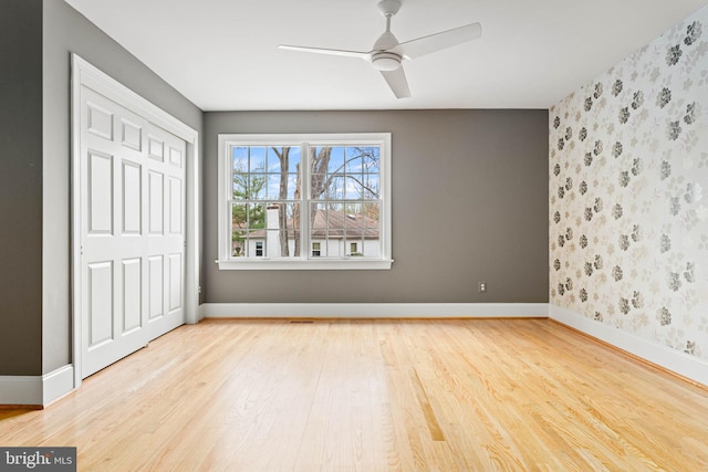 607 Newtown Rd, Berwyn, PA 19312 - unfurnished bedroom with baseboards, a closet, wallpapered walls, and wood finished floors